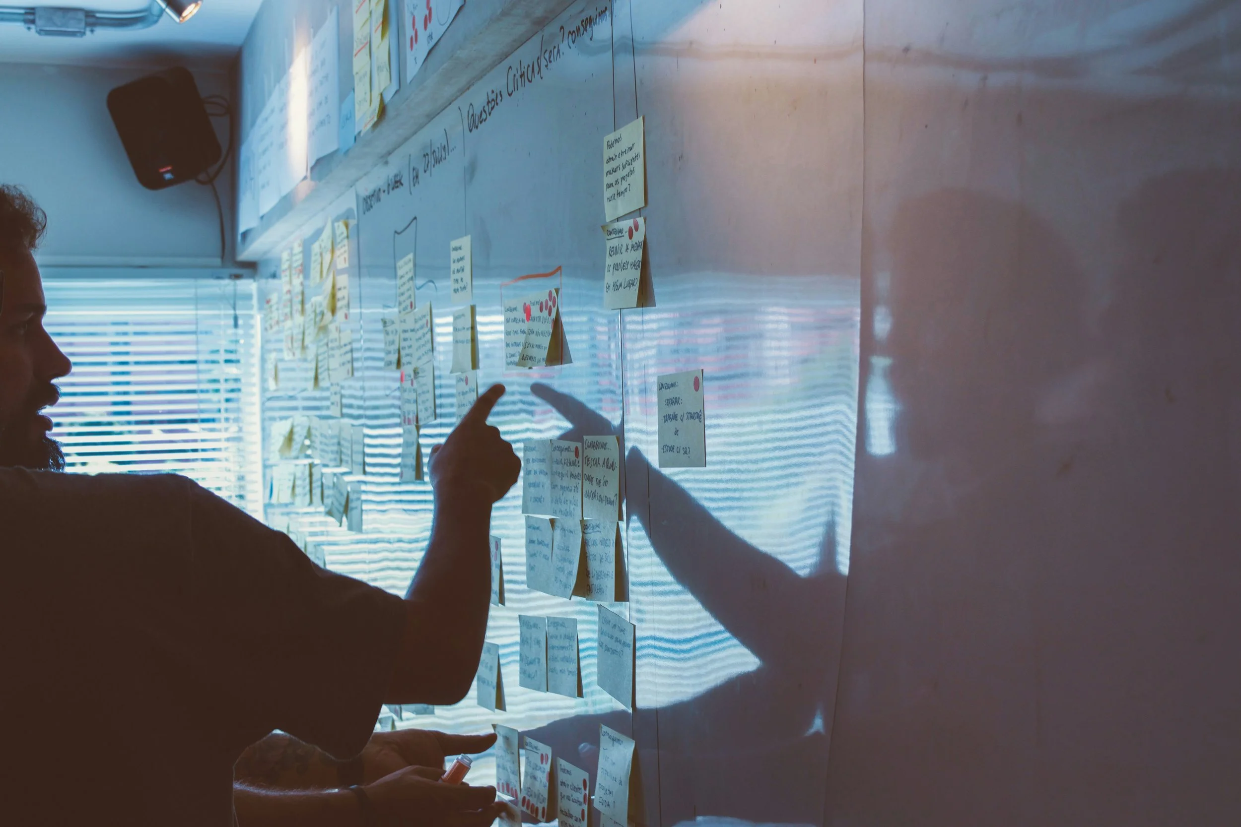 A strategy workshop with ideas and notes arranged on a wall