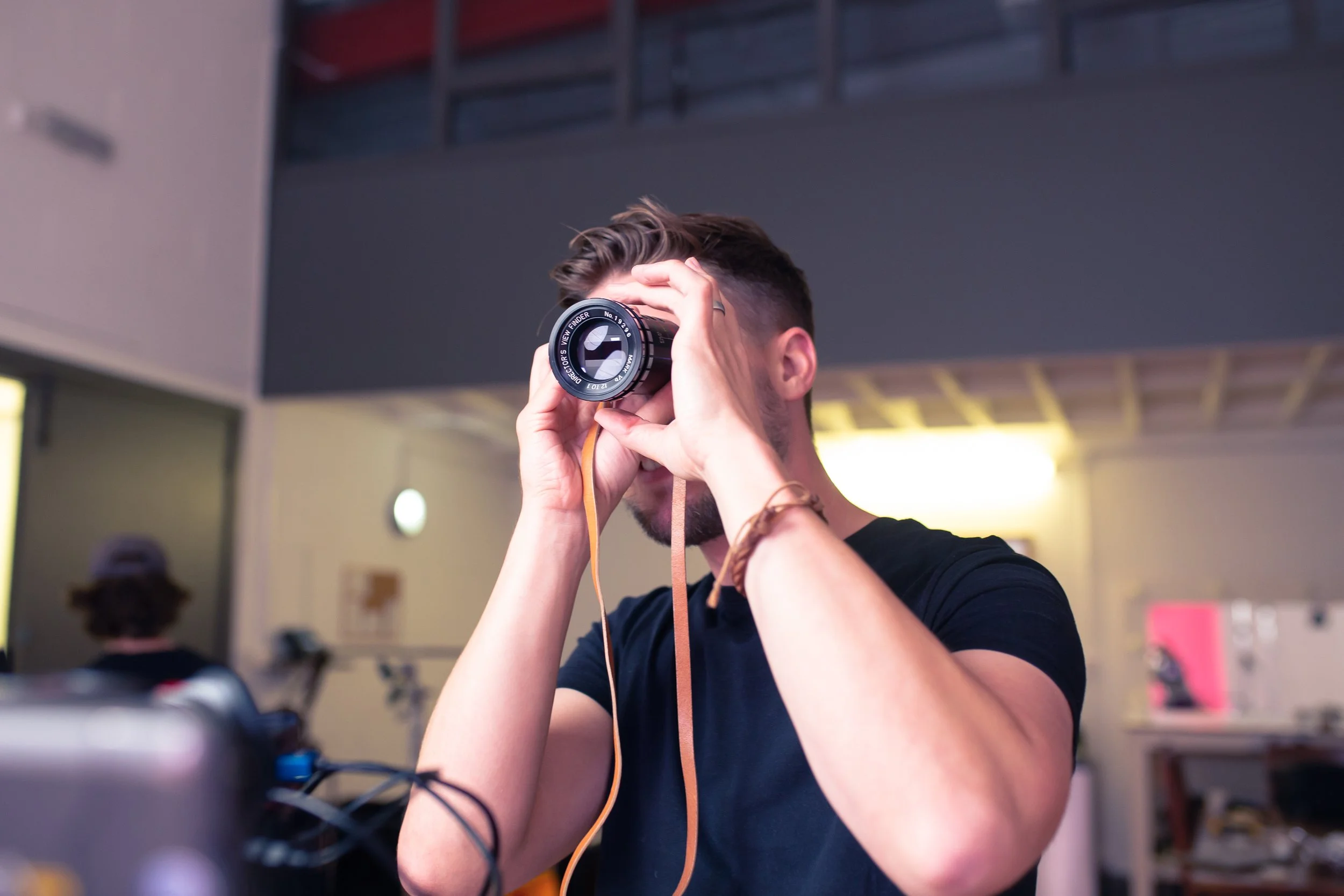Lewis framing a shot with a director’s viewfinder