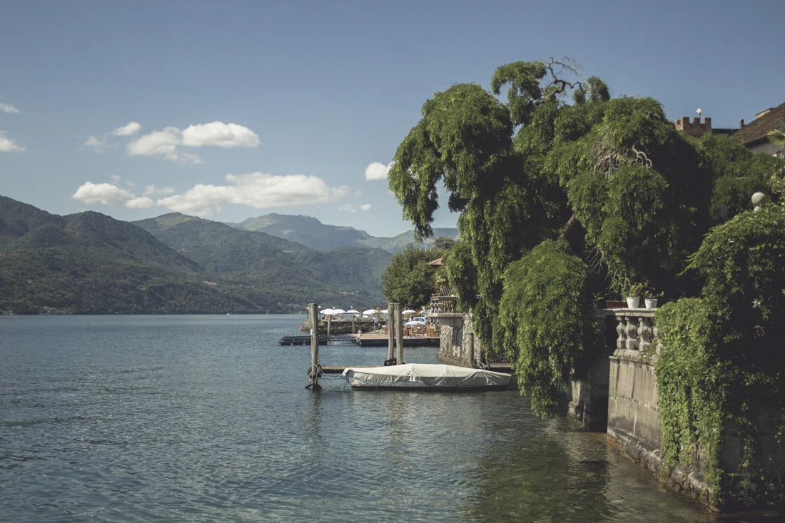 Trees and a small boat beside a mountain lake