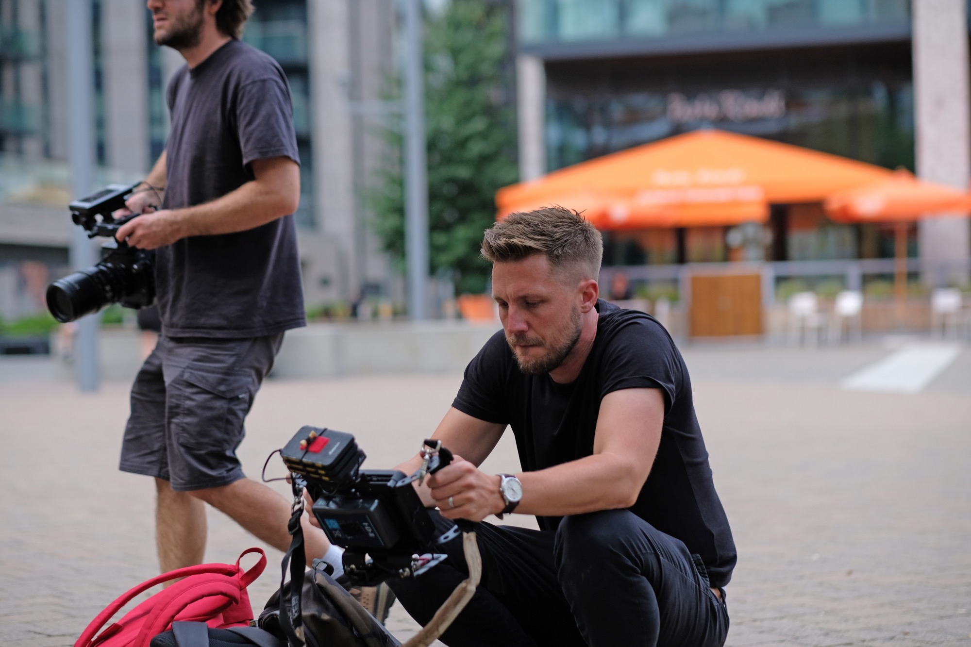 Lewis and a camera operator preparing for a location shoot