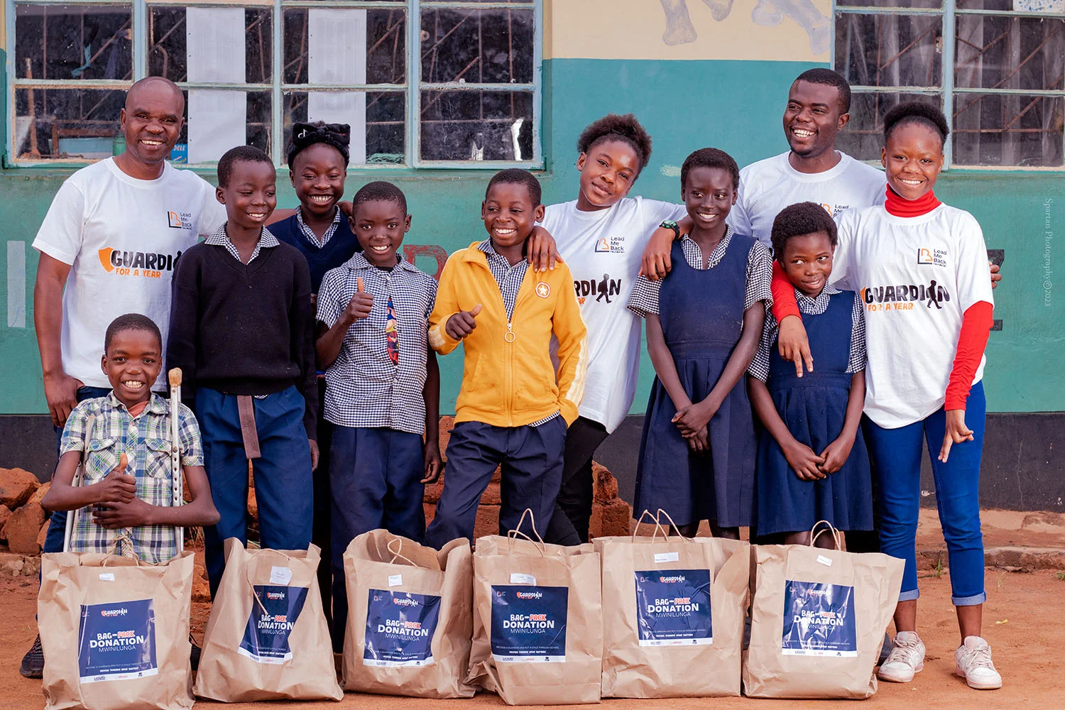 Lead Me Back community members and children with donated bags